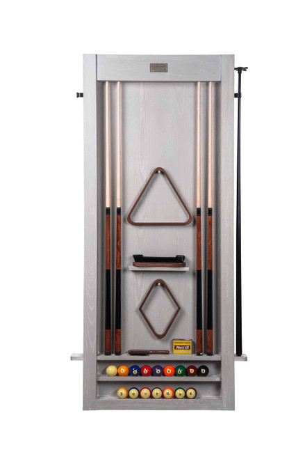 The Alta Wall Cue Rack in White Wash on Ash is mounted cleanly against a textured backdrop, holding six full-length cues in a symmetrical vertical layout. Below, the Sawyer Twain Trophy Kit is staged with its premium ball set, triangle rack, and cue accessories—adding a polished, ready-to-play vibe to this American Heritage Billiards exclusive. A cohesive setup for design-conscious game rooms, only at SawyerTwain.com.