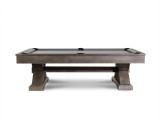 Side profile of the Jasper Slate Pool Table by Nixon Billiards, set against a clean concrete floor, emphasizing its rustic farmhouse design and solid wood construction. The weathered slate finish combined with sleek lines adds a touch of charm and sophistication, making it an ideal choice for a stylish and functional game room.