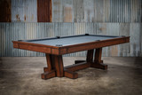 Elegant transitional contemporary pool table, the Doc & Holliday Caroline Slate Pool Table, showcasing its sleek frame and classic design. The image highlights the table's sophisticated wood finish and premium felt, set against a tastefully decorated game room that exemplifies luxury and style.