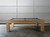 Side view of the Paula Parsons Slate Pool Table in Glazed Maple finish by Doc & Holliday, showcasing its smooth maple wood craftsmanship, elegant dining functionality, and genuine leather drop pockets, all set against a clean white background.