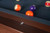 The Jackie's Pool Table in Pecan Bourbon Walnut features stunning Mother of Pearl billiard sights, adding a touch of elegance to your game. Fully customizable, made in the USA by Doc & Holliday, exclusively at Sawyer Twain.