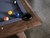 Close-up of the Desyn’s genuine leather drop pocket and walnut rail accent. Shows material texture and finish quality, ideal for highlighting premium craftsmanship.