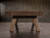 Short-end view of the Nixon Desyn Pool Table showcasing the tapered Parsons-style legs slightly angled outward for stability and mid-century modern flair. The image highlights the sculptural lines and Gray Walnut wood grain, perfect for visualizing how the table anchors smaller or open-concept spaces