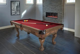 The Brunswick Botanic 8' Slate Pool Table set up in a stylish modern rustic game room with friends gathered around for a match. The Brunswick logo subtly visible on the table, reflecting the luxury and heritage of Brunswick Billiards. A perfect blend of premium craftsmanship and elegant design, ready for hours of competitive play and casual fun.