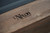 Close-up of the engraved Nixon Billiards logo on the end rail of the Bryant Slate Pool Table by Nixon Billiards. This exclusive engraving adds a signature touch, showcasing the craftsmanship and luxury of the table. Available only through Sawyer Twain, it reflects the table’s high-end design and attention to detail.
