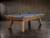 Three-quarter view of the Nixon Billiards Desyn Slate Pool Table in Gray Walnut, captured in a beautifully styled interior with soft, ambient lighting and rich, tonal textures. The setting evokes a high-end, design-forward atmosphere with moody finishes and clean architectural lines. The image highlights the table’s full silhouette, tapered legs, and warm wood tones — ideal for inspiring elevated home game room environments.