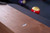 This detail shot showcases the Alta Slate Pool Table’s precision-cut mother-of-pearl diamond sights, inlaid along the ash wood rails. The iridescent diamond accents subtly catch the light, offering a refined contrast against the customizable felt and warm Honey Ash finish. A functional and luxurious detail, these sights reflect the table’s blend of serious gameplay and modern design—available exclusively at Sawyer Twain.