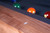 This detail shot showcases the Alta Slate Pool Table’s precision-cut mother-of-pearl diamond sights, inlaid along the ash wood rails. The iridescent diamond accents subtly catch the light, offering a refined contrast against the customizable felt and warm Honey Ash finish. A functional and luxurious detail, these sights reflect the table’s blend of serious gameplay and modern design—available exclusively at Sawyer Twain.