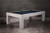 The Alta Slate Pool Table by American Heritage Billiards is shown in a bright, coastal-inspired interior, styled at a ¾ angle. Featuring a White Wash on Ash finish exclusive to Sawyer Twain, this Parsons-style table anchors the space with casual elegance—blending performance design with a fresh, modern aesthetic that’s perfect for beach homes, open-concept spaces, or elevated game rooms.