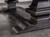 A focused look at the trestle-style base in Distressed Black, showing off the table’s architectural weight and crossbeam detail.