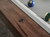 Zoomed-in image of the metal sights set into the rail, designed for precision alignment. Their subtle shimmer plays nicely against the earthy tones of the wood.