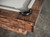 The leather pocket is featured in a styled room setting, offering a detail-rich moment of function and texture. Lighting draws out the craftsmanship.