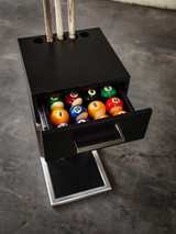 A stylish game room setting featuring the stainless steel floor rack placed next to a luxury pool table. The image highlights the open drawer with billiard balls neatly stored inside, showcasing the rack’s sleek design and functional storage. The background should exude a high-end, modern aesthetic with warm lighting and a refined interior.