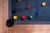 A polished, overhead lifestyle image showing the Sawyer Twain Trophy Kit pool balls perfectly racked on the Vancouver Slate Pool Table’s playing surface. The vibrant colors and premium finish of the Trophy Kit set contrast beautifully with the custom felt and Honey Ash finish—visually bold, game-night ready, and unmistakably Sawyer Twain. Designed for queries like “luxury pool balls set on designer table,” “Trophy Kit billiard balls styled photo,” or “exclusive Sawyer Twain pool table setup with premium accessories.”