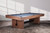 The Vancouver Slate Pool Table in Honey Ash, styled in a luxury game room with ambient lighting and warm neutral décor. The custom reeded wood legs and matte slate surface make it a conversation-starting centerpiece, perfect for keywords like “modern slate pool table styled in designer home” or “game room furniture with contemporary wood finish.