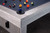 A close-up scene shows the Sawyer Twain Trophy Kit balls resting on the customizable Championship felt. This exclusive American Heritage Billiards table shines under soft lighting, evoking a game-night ambiance that’s all class, no clutter.