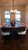 Close-up lifestyle view of the Otis Pool Table transformed into a dining table, styled with modern place settings, upholstered chairs, and neutral seasonal accents in a farmhouse-inspired home


