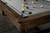 Close-up of the Steel Grey Championship Teflon felt on the Nixon Billiards Hunter Pool Table, featuring the Sawyer Twain Trophy Kit billiard balls. The professional-grade felt provides a smooth, durable surface for gameplay, while the premium billiard balls add to the table’s high-end appeal and precision.

